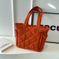 Quilted nylon tote bag in burnt orange featuring side pockets and a zipper closure - Orange