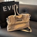 Khaki corduroy tote bag with white rope handles and embroidered detail in lifestyle setting - Khaki