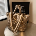 Premium champagne gold quilted puffer tote bag for women shown in lifestyle setting - Gold