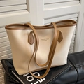 Borsa tote minimalista crema e marrone su un divano in pelle nera - Bianco Sporco