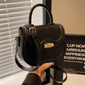 Classic black saddle crossbody bag with golden hardware and round top handle - Black Style 1