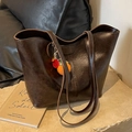 Dark brown faux leather tote bag with long straps and a decorative orange charm - Coffee with Pendant