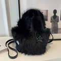 Black fuzzy faux fur bucket bag with star pendant and sleek leather shoulder strap - Black