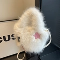 White faux fur bucket bag with a pink star patch and slim leather crossbody strap - White