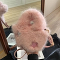 Pink faux fur bucket bag featuring glittery star patches and a slim shoulder strap - Pink