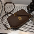 Deep brown quilted crossbody bag with vintage gold emblem and adjustable strap - Brown