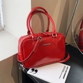 Elegant red patent leather Boston handbag for weddings featuring silver hardware - Red