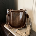 Retro dark brown bucket bag with textured leather and a wide geometric woven strap - Coffee (Silver Logo)