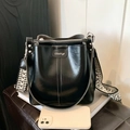 Black leather bucket bag with a stylish geometric woven wide strap in a minimalist design - Black (Silver Logo)