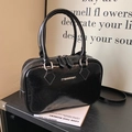 Elegant black patent leather Boston handbag with metallic logo and adjustable strap - Black