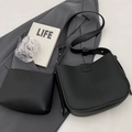 Classic black litchi pattern bucket bag and matching zipper pouch set on grey suit - Black