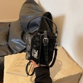 Chic black bucket bag with silver NR logo on a stylish stone and leather setting - Black