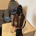 Retro brown bucket bag in matte leather featuring silver MR logo and drawstring insert - Brown
