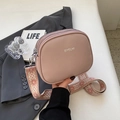 Pink textured leather crossbody bag with dual zippers and wide patterned strap - Pink