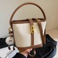 Chic cream and brown bucket bag with gold twist lock and a cute white plush charm - With Pendant / Off White