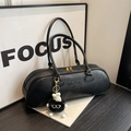Chic black cylindrical underarm bag with smooth leather texture and plush monster charm - Black With Pendant