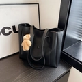 Large black leather tote bag with external pocket and a small brown plush bear charm - Black With Pendant