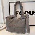 Quilted dark grey canvas tote bag with padded knotted straps and spacious design - Gray