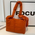 Vibrant orange quilted puffer tote bag with thick padded strap and crossbody design - Orange
