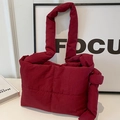 Burgundy quilted puffer tote bag with knotted strap handle for casual winter style - Burgundy