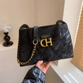 Quilted black crossbody bag with gold chain strap and metallic logo hardware - Black