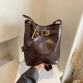 Deep brown vintage bucket bag in textured synthetic leather with golden buckle hardware - Brown