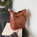 Classic retro brown leather bucket bag for women with adjustable golden metal buckle - Brown