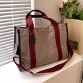 Beige canvas tote bag with burgundy straps and brown leather trim on white windowsill - Large / Gray
