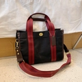 Black canvas tote bag with red striped handles and gold twist-lock closure - Small / Black