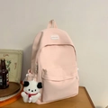 Minimalist light pink nylon backpack with front pocket and plush puppy keychain detail - Pink With Pendant