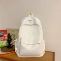 White minimalist nylon backpack for women featuring large front pocket and Boka Bag logo - White Without Pendant