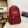 Minimalist burgundy nylon backpack with white front zipper and RUIKEDA brand logo - Red