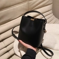 Minimalist black leather bucket bag with top handle and gold-tone hardware detail - Universal Specification / Black
