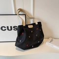 Black canvas tote bag featuring colorful letter embroidery and khaki handles - Black