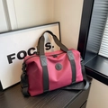Deep rose red waterproof Oxford cloth travel bag with durable black carrying handles - Burgundy