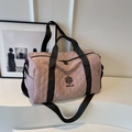Pink quilted travel duffel bag with black adjustable shoulder strap and NINGJIA logo - Pink