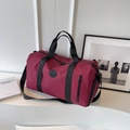 Deep burgundy nylon travel bag with black handles and adjustable shoulder strap - Burgundy