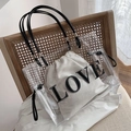 Transparent PVC tote bag with white 'LOVE' drawstring pouch and black handles - Clear