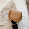 Chic beige leather saddle bag with shoulder strap and subtle logo embossing - Khaki