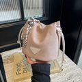 Sac seau rose à cordon avec bandoulière chaîne à boules argentées à la main - Rose