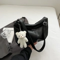 Minimalist black PU leather tote bag with a white plush bear charm and adjustable strap - Black