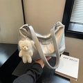 Silver textured shoulder bag with metallic finish and cute plush bear charm - Silver