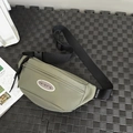 Minimalist sage green sporty chest bag with adjustable black strap and oval patch detail - Green