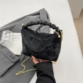 Chic black pleated handbag with vintage texture and gold chain on a neutral background - Black