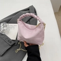 Pink pleated handle handbag with matte texture and gold chain strap shown in hand - Pink