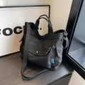 Minimalist black canvas tote bag with adjustable shoulder strap and utility front pocket - Black