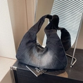 Vintage crescent denim shoulder bag with dark wash patchwork and metal zipper closure - Black