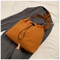 Caramel orange nylon drawstring tote bag with black brand label on grey blazer - No Pendant / Brown