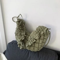 Chic green quilted dumpling bag with ruffle edges and minimalist shoulder strap style - Green
