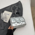 Silberne Stepptasche mit Herzschnalle auf minimalistischer weißer Fläche - Silber Groß